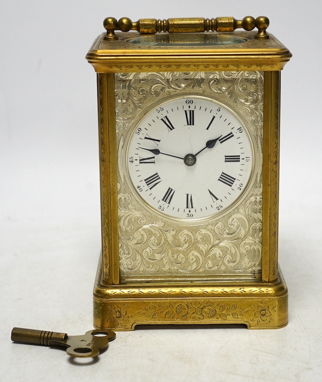 An engraved brass carriage clock by Richard & Cie, serial number 648, with key, 14cm. Condition - fair, dial cracked. Not tested as working